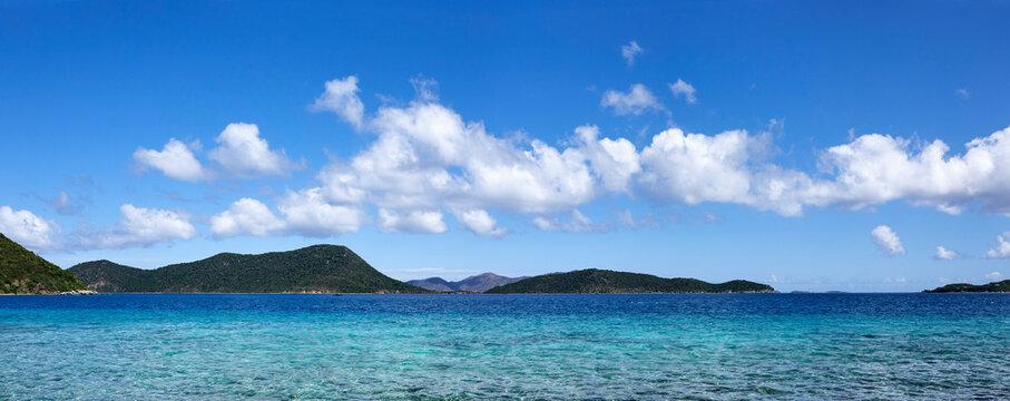 Blue sky with puffy clouds over Caribbean sea