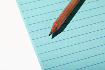 Pencil on pad of blue line paper