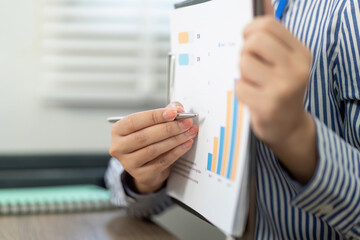 Business Analysis and Reporting. Professional reviewing data charts in a modern office.