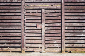 Wooden ancient fence and door of the barn.