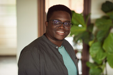Young African man smiling in his living room at home