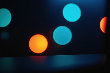 A blurry image of a traffic light in the dark, suitable for use as a background or atmospheric effect
