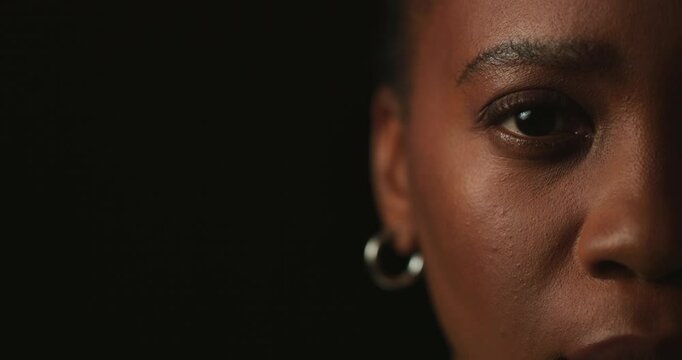 African woman, face and depression in studio with mock up space, ptsd and trauma by black background. Person, model and portrait with anxiety for stress, worry and sad with mental health in Nigeria