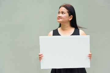 businesswoman holding blank board