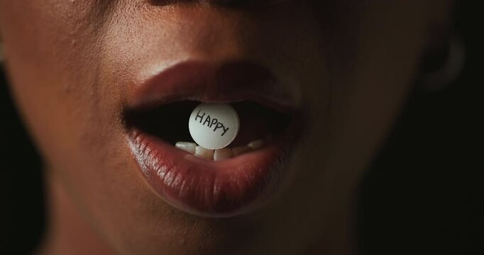 Mouth, pills and addiction in studio closeup with text for mind altering drugs by black background. Person, tablet and illegal medicine with opioid crisis, mood and happy with chemical compound