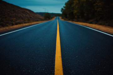 Obraz premium A straight empty road with a yellow line marking the center, suitable for travel or infrastructure-related projects