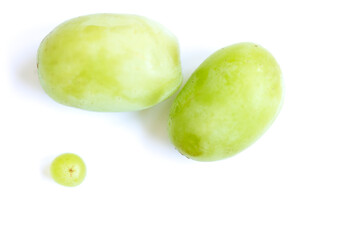 Macro shot of two large green grapes and one tiny grape on a white background. A playful, natural still life symbolizing growth, beauty, and summer fruit freshness.