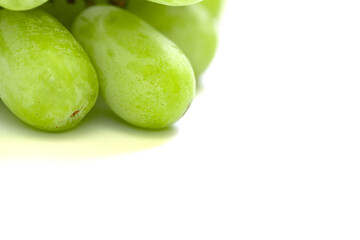 Macro shot of two large green grapes and one tiny grape on a white background. A playful, natural still life symbolizing growth, beauty, and summer fruit freshness.