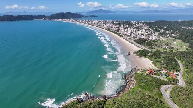 Mariscal Beach In Bombinhas Santa Catarina Brazil. Turquoise Ocean Waves Gently Crashing On Tropical Beach. Shore Clouds Beach Sea. Outside Beach Panning Wide. Bombinhas Santa Catarina.