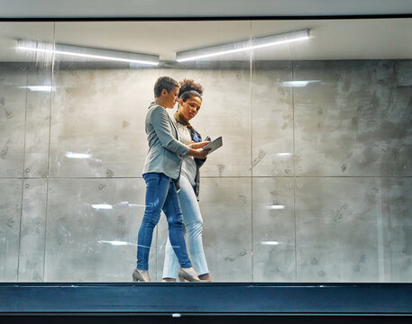 business meeting businesswoman woman young office presentation colleague teamwork document papers hallway corridor tablet computer standing walking