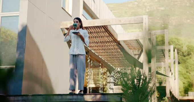 Morning, coffee and woman on patio in home for relaxing, calm and reflection in backyard. Thinking, thoughtful and person with drink, warm beverage and caffeine outdoor for peace, wellness and rest