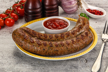 Grilled beef sausages with sauce