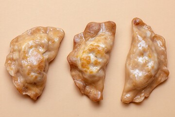 Three delicious pierogi on neutral background