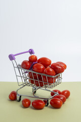 Cherry tomatoes in a grocery basket. Healthy food background. 

