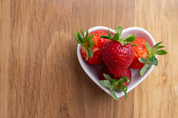 Ripe strawberries on a plate on a light background. Healthy food.
