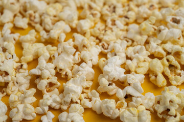 Popcorn on a colored background. Space for text. Tasty snack