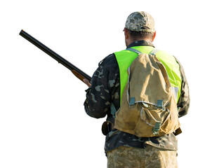 Silhouette of a hunter with a gun in the reeds against the sun, an ambush for ducks with dogs