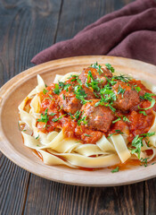 Beef meatballs with tomato sauce served over fresh tagliatelle pasta, Italian style