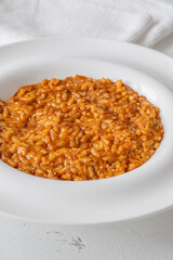 Creamy tomato risotto on clean white plate