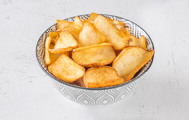 Golden potato dippers served hot in bowl, crispy edges and rustic feel