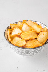 Golden potato dippers served hot in bowl, crispy edges and rustic feel