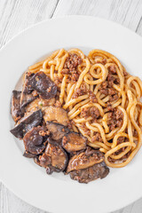 Unagi udon noodles served with beef and crispy garlic thyme shiitake
