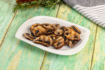 Tasty hot grilled champignon mushrooms