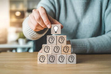 Person placing lightbulb on question mark blocks
