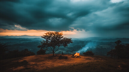 Dramatic Sunset Landscape with Campfire and Tree Silhouette
