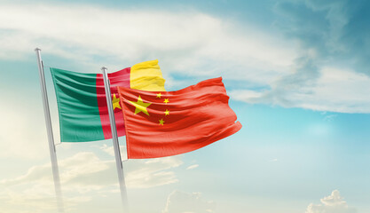 Cameroon and China flags waving in beautiful sky. Two country flag for agreement or deal. Cameroon...