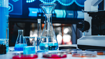 Modern laboratory setup with microscope, glassware, and blue chemical solutions, representing advanced scientific research, biotechnology, and data-driven experiments.
