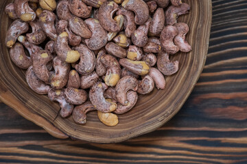 Cashews in Wooden Bowl on Wooden Background