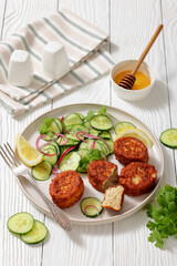 dutch fish cakes with cucumber salad on a plate
