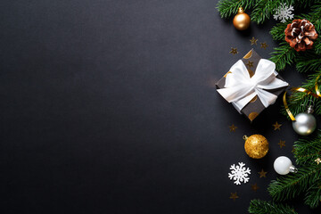 Black christmas background. Christmas present with golden decorations