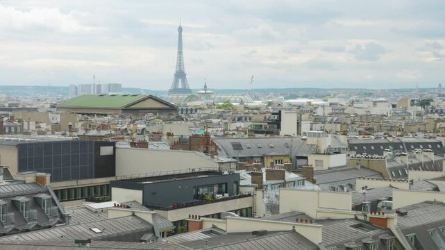 Panoramic top view of Paris, rooftops, Eiffel Tower from the free observation deck on the roof of the Galeries Lafayette.