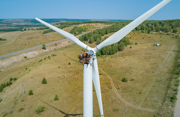 Aerial shot of wind turbine with fire damage in a rural landscape during the daytime