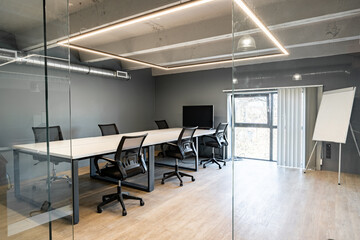 Conference room with modern design and glass walls in a corporate office setting during daylight