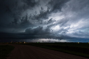 Lightning bolts flash through a dark storm cloud, illuminating a dramatic sky filled with shadow, texture, and moody atmosphere, capturing the raw power, danger, and beauty of epic weather.