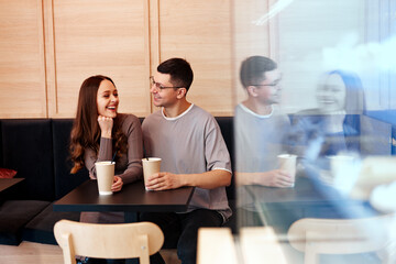 Couple enjoying coffee and conversation at a cozy cafe in the afternoon