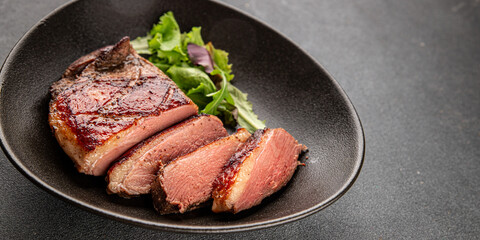Duck breast roast meat poultry fresh delicious gourmet food background on the table rustic food top view copy space