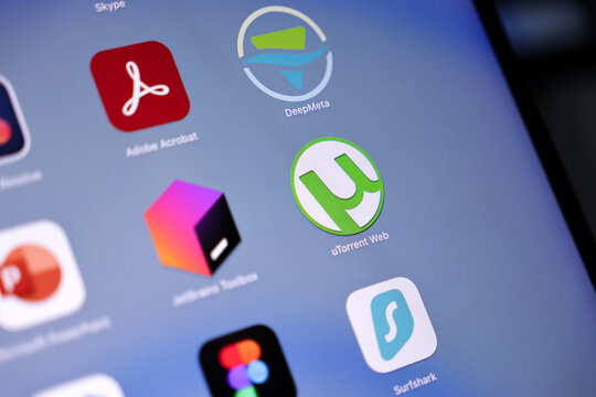 The prominent uTorrent Web application icon is clearly displayed on a digital device screen, representing modern file sharing and online media access.