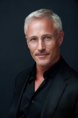 Fototapeta premium headshot of middle-aged man, soft lighting, subtle smile, clean background, professional portrait