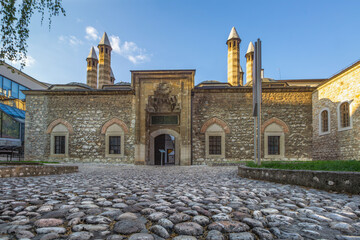 Historic stone building in Sarajevo of the Gazi Husrev-Beg Mosque with distinctive minaret against...