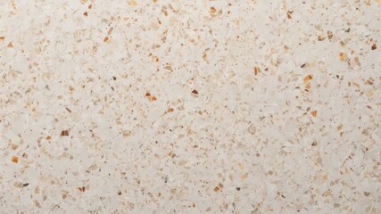 Cream-colored speckled terrazzo texture with small chips of beige, brown, and white
