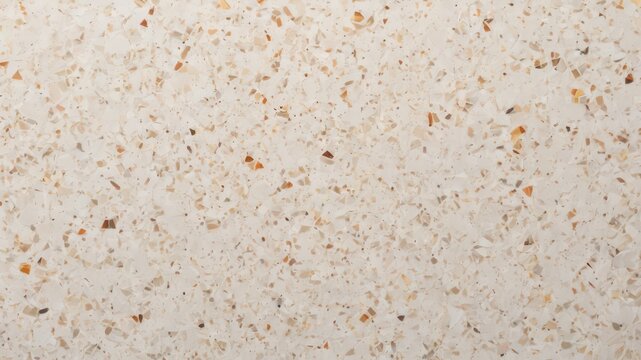 Cream-colored speckled terrazzo texture with small chips of beige, brown, and white