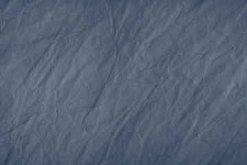 Abstract wrinkled dark blue crumpled paper texture background