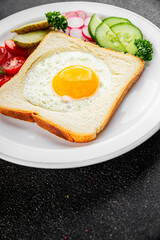 Fried gashouse eggs in bread egg in the basket delicious snack breakfast in a bowl fresh delicious gourmet food background on the table rustic food top view copy space