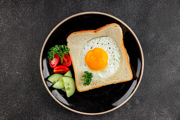 Fried gashouse eggs in bread egg in the basket delicious snack breakfast in a bowl fresh delicious gourmet food background on the table rustic food top view copy space