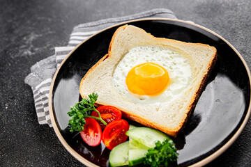 Fried gashouse eggs in bread egg in the basket delicious snack breakfast in a bowl fresh delicious gourmet food background on the table rustic food top view copy space
