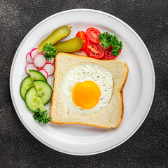 Fried gashouse eggs in bread egg in the basket delicious snack breakfast in a bowl fresh delicious gourmet food background on the table rustic food top view copy space